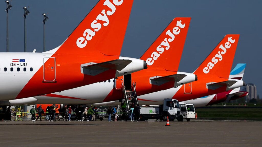 Several easyJet airplanes parked with their white and red colors.