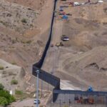 A panoramic view of several machines building Trump border wall that separates Mexico from Texas.