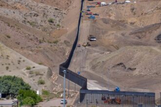 A panoramic view of several machines building Trump border wall that separates Mexico from Texas.