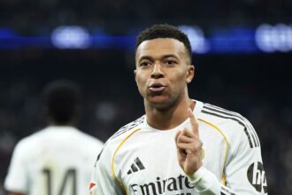 The excellent French player celebrating one of his goals while wearing Real Madrid’s white kit.