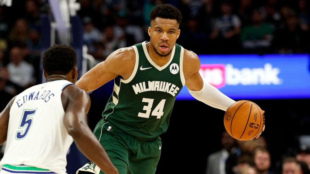 The Greek beast of the NBA, Giannis Antetokounmpo, holding the ball while facing another great opposing player.
