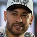 Neymar giving a press conference in front of many news outlets.