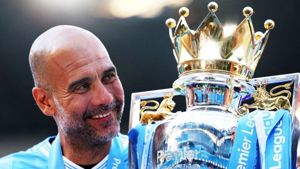 The Spanish coach and former footballer Pep Guardiola lifting the Premier League trophy