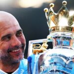 The Spanish coach and former footballer Pep Guardiola lifting the Premier League trophy