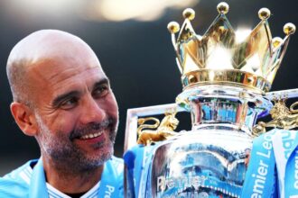 The Spanish coach and former footballer Pep Guardiola lifting the Premier League trophy