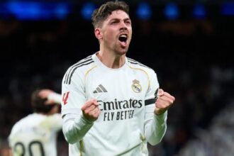 Federico Valverde celebrating euphorically and powerfully with both fists clenched.