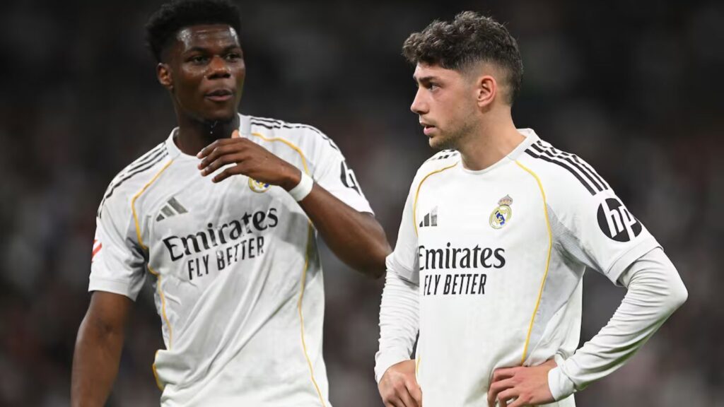 Both players with unfriendly expressions in the middle of a football match.