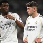 Both players with unfriendly expressions in the middle of a football match.