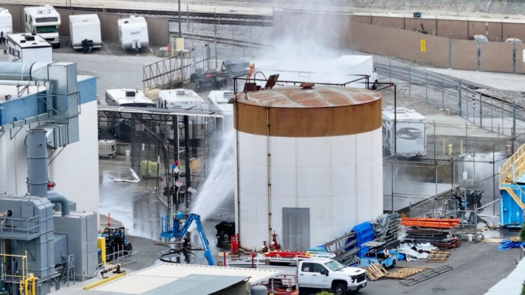 Southern California areas evacuated over risk of industrial tank explosion A large tank filled with chemicals being sprayed with water or another liquid to prevent the gas from spreading rapidly.