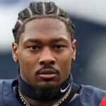 The well-known wide receiver wearing the New England Patriots uniform with a very serious expression before the start of a game.