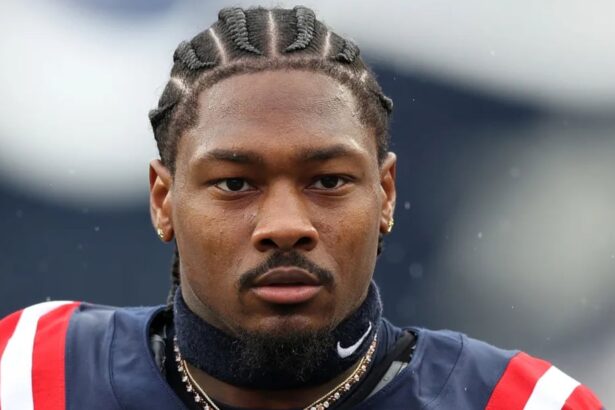 The well-known wide receiver wearing the New England Patriots uniform with a very serious expression before the start of a game.