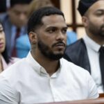 The Major League Baseball star inside a courtroom surrounded by his lawyer and several family members