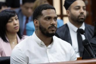 The Major League Baseball star inside a courtroom surrounded by his lawyer and several family members