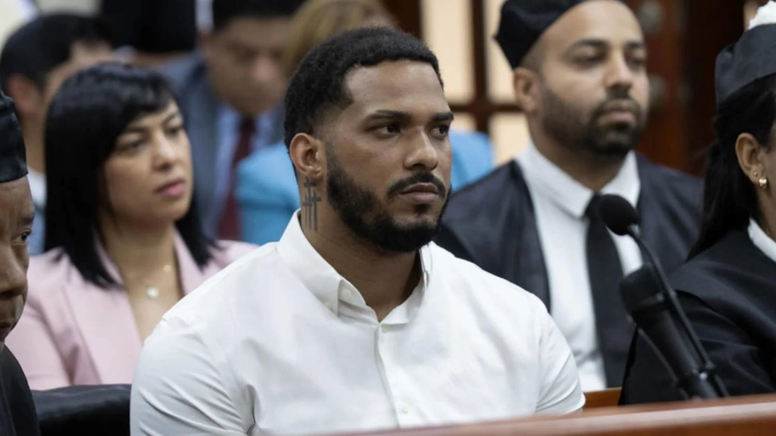 The Major League Baseball star inside a courtroom surrounded by his lawyer and several family members