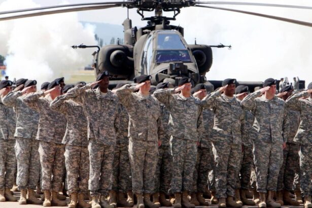 Many American soldiers saluting with their hands on their foreheads, with several military helicopters behind them.