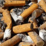 United States reaches historic low in smoking rates and marks a generational shift A large pile of cigarettes stacked and burned on a table.