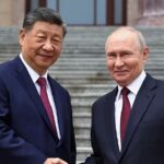 The top leaders of China and Russia shaking hands in public in front of numerous news outlets