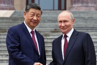 The top leaders of China and Russia shaking hands in public in front of numerous news outlets