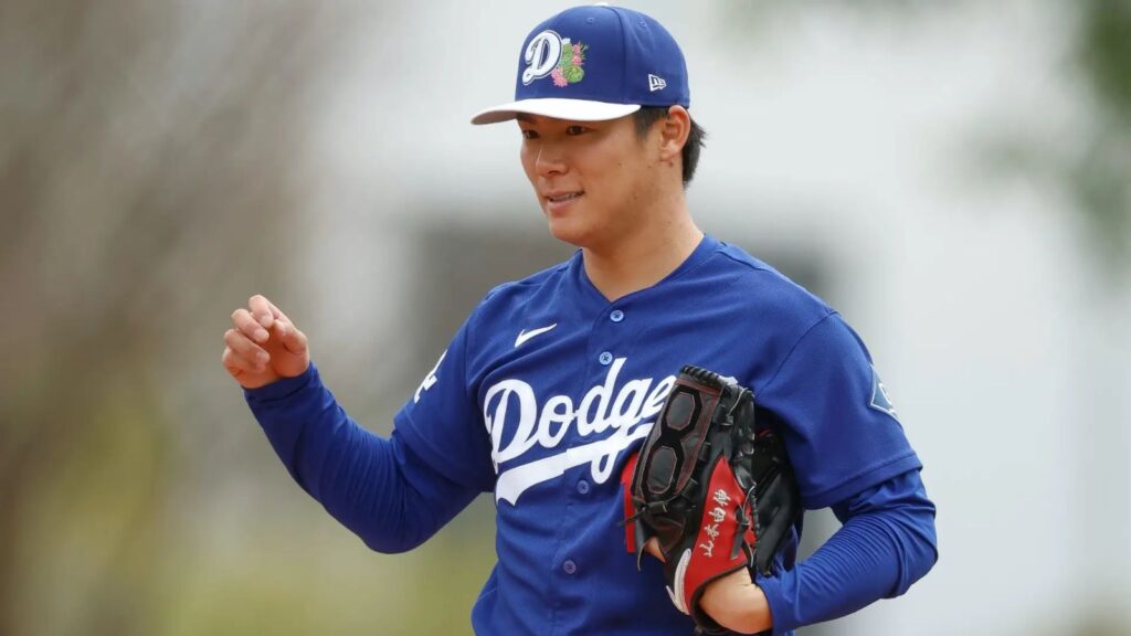 Yoshinobu Yamamoto preparing on the mound to throw one of his pitches.