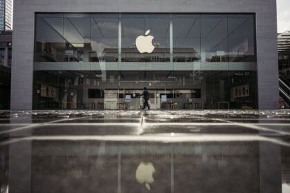 One of Apple’s stores on a rainy day, with its iconic apple logo standing out among other shops
