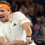 Alexander Zverev wins Roland Garros and reaches the pinnacle of his career The renowned tennis player about to hit the ball while sticking his tongue out