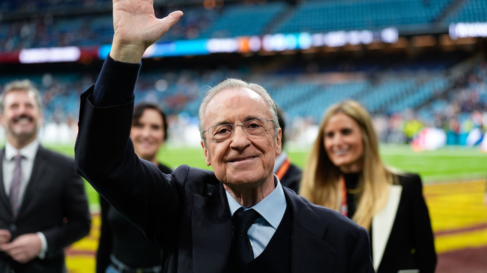 Florentino waving to Real Madrid fans from the pitch after a victory