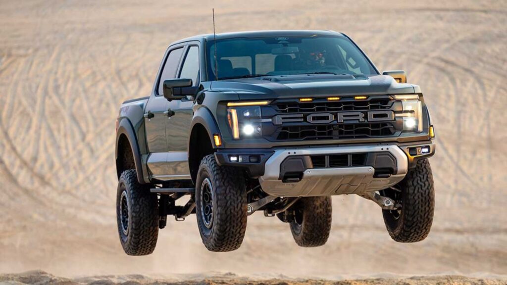 A rugged Ford pickup truck soaring through the air after hitting a ramp.