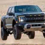 A rugged Ford pickup truck soaring through the air after hitting a ramp.