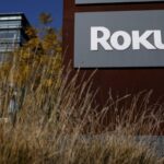 A very large building with a sign that says “ROKU” across its entire front