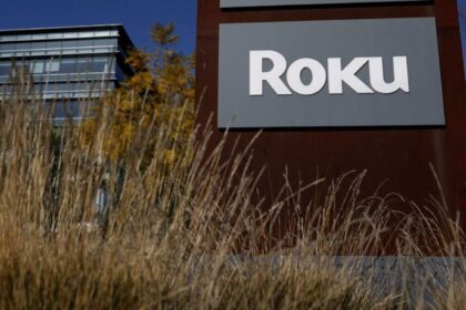 A very large building with a sign that says “ROKU” across its entire front