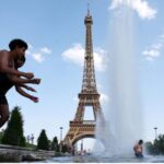 Several children jumping into a swimming pool in front of the Eiffel Tower