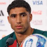 The Moroccan player staring intently at a point during a press conference while listening to journalists