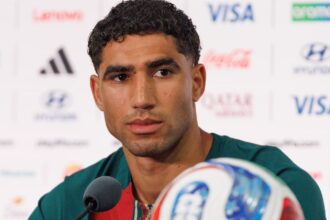 The Moroccan player staring intently at a point during a press conference while listening to journalists