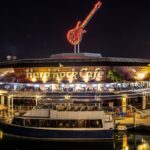 Hard Rock Cafe at Bayside Marketplace in Miami closes after more than 30 years of history A panoramic view of the Hard Rock Cafe at night, with its eye-catching lights illuminated