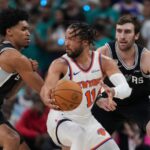Jalen trying to dribble past two Spurs players in order to score