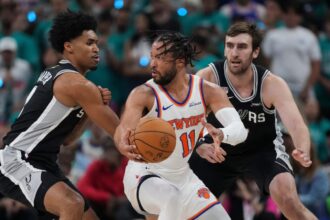 Jalen trying to dribble past two Spurs players in order to score