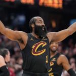 The Cavaliers player raising his arms after scoring a basket