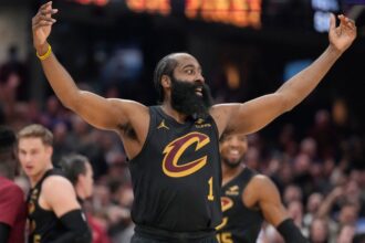 The Cavaliers player raising his arms after scoring a basket