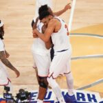 Several Knicks players embracing each other while celebrating their victory in Game 4