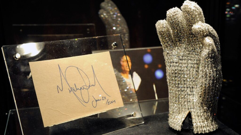 Michael Jackson’s glove displayed vertically with the King of Pop’s original signature beside it