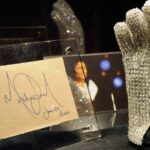 Michael Jackson’s glove displayed vertically with the King of Pop’s original signature beside it