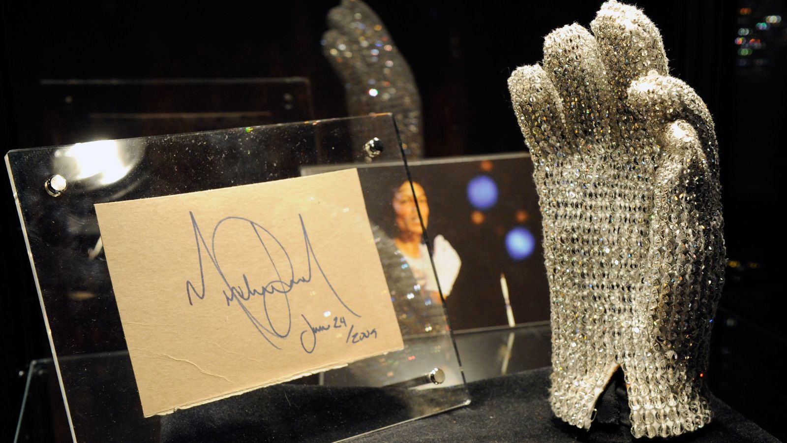 Michael Jackson’s glove displayed vertically with the King of Pop’s original signature beside it