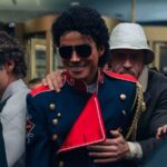 Michael Jackson surrounded by several members of his security team while leaving a stage