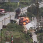 A bridge being destroyed by a massive explosion