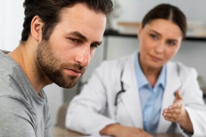 A doctor giving news to a man who has a very sad expression on his face