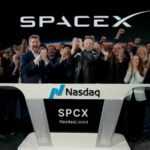 Elon and several people celebrating during an interview after the positive news of SpaceX's stock market debut