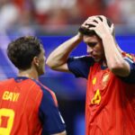 Two Spanish players holding their heads in frustration after missed chances against Cape Verde
