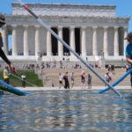 Temporary closure of Lincoln Memorial reflecting pool draws attention in Washington Several people with drainage equipment removing water from the important and well-known park in Washington D.C.