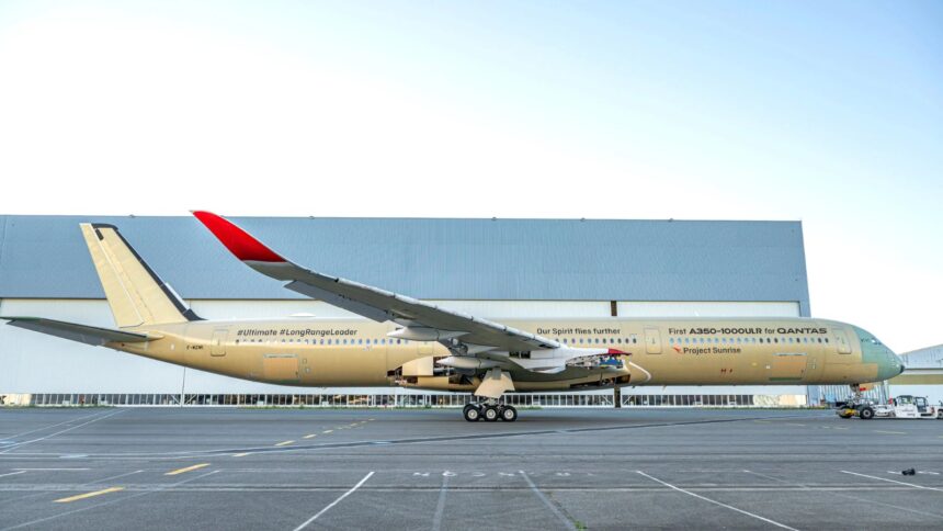 The impressive aircraft seen from one side, showcasing its beautiful gold and white colors