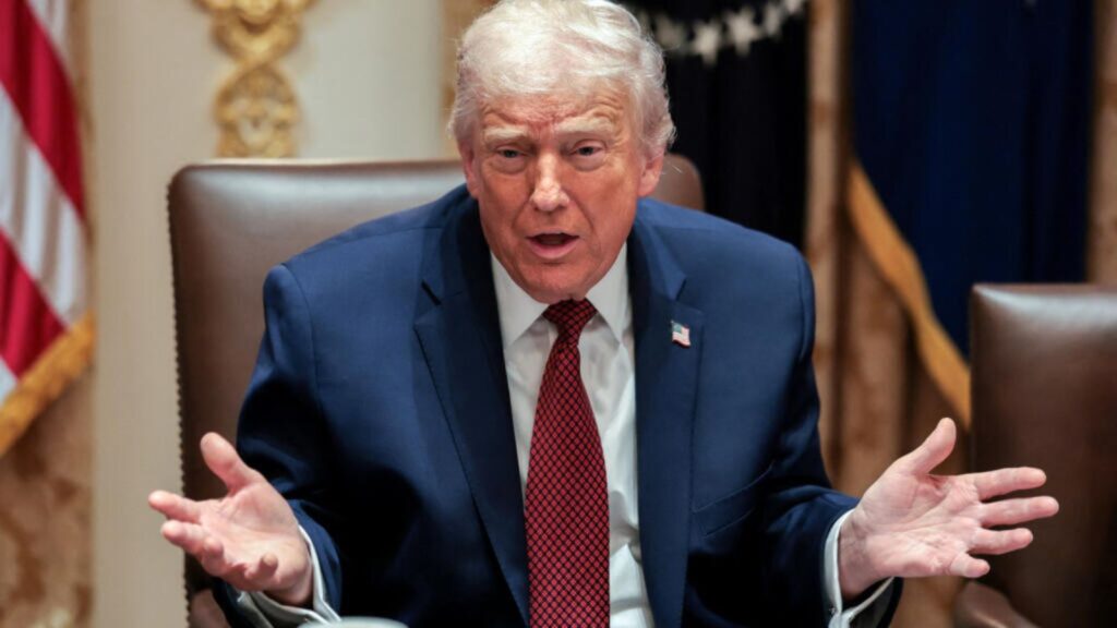 Trump backs down: U.S. cancels billion-dollar fund for politically persecuted individuals Trump opening his hands and making gestures while speaking to someone in the audience.